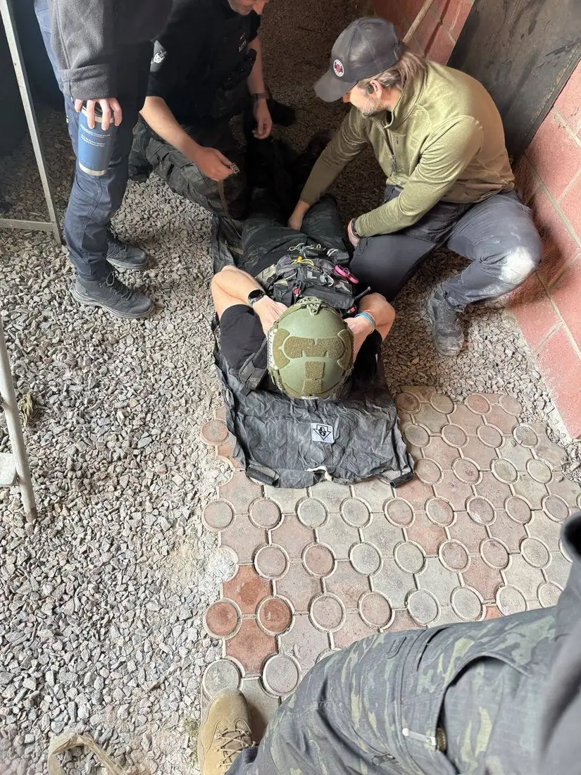 Team strapping a casualty onto a Pocket Litter